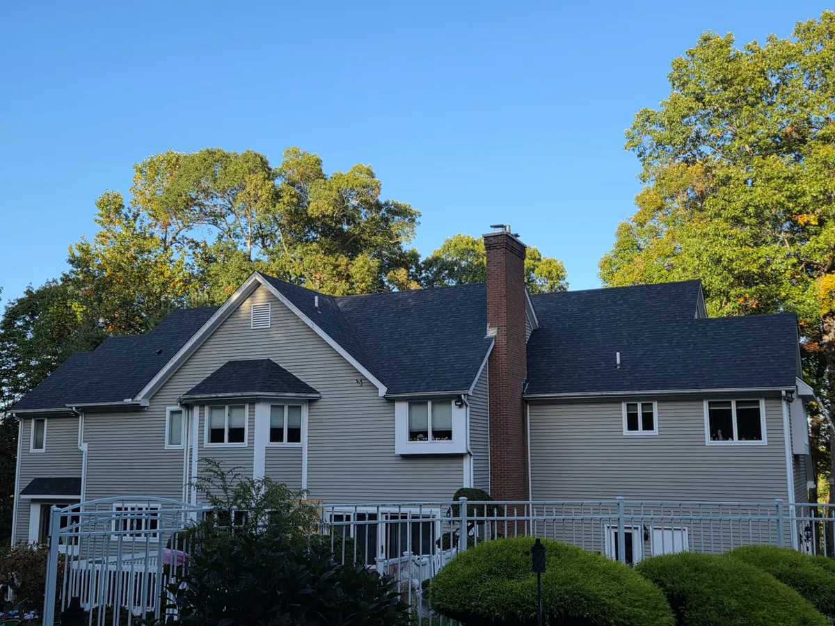Completed home with new charcoal shingle roof