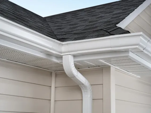 White aluminum gutters and downspout corner detail