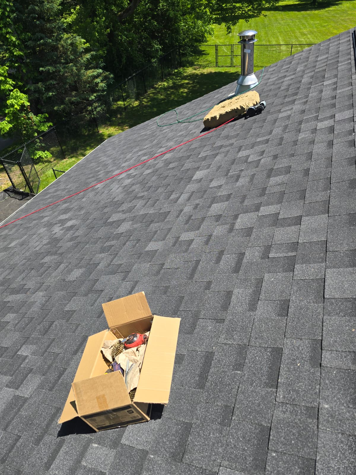 Finished shingle roof with chimney flashing