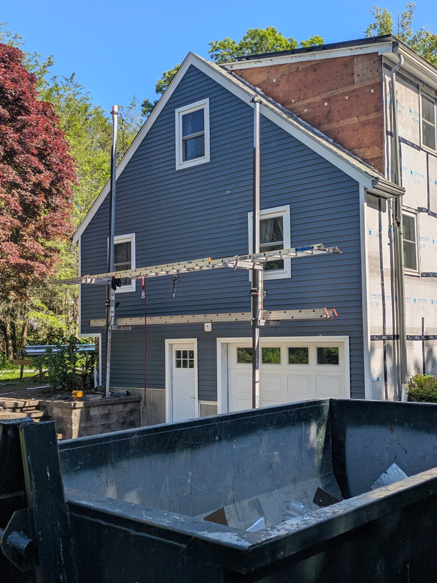 Side view of home with newly installed blue siding